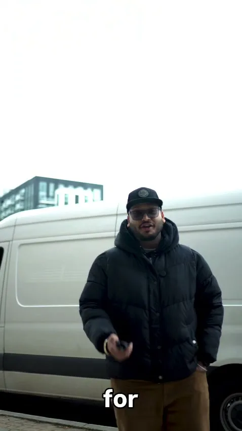 An Optimum team member introducing the moving service beside a van
